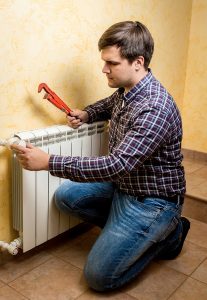 heating technician working on heating system