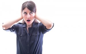 woman covering her ears isolated on a white background