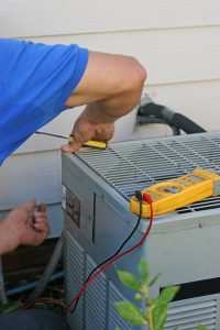 technician-working-on-air-conditioning-unit