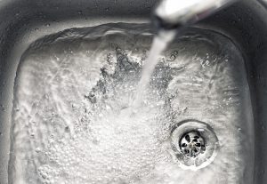 sink-faucet-with-water-going-into-drain