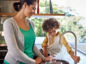 woman-and-child-getting-water-from-kitchen-sink