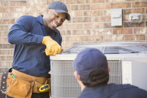 two-techs-working-on-outside-ac-unit