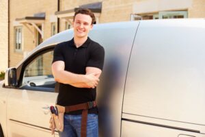 smiling-man-standing-in-front-of-service-van