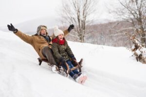 grandpa-riding-sled-with-grandaughter